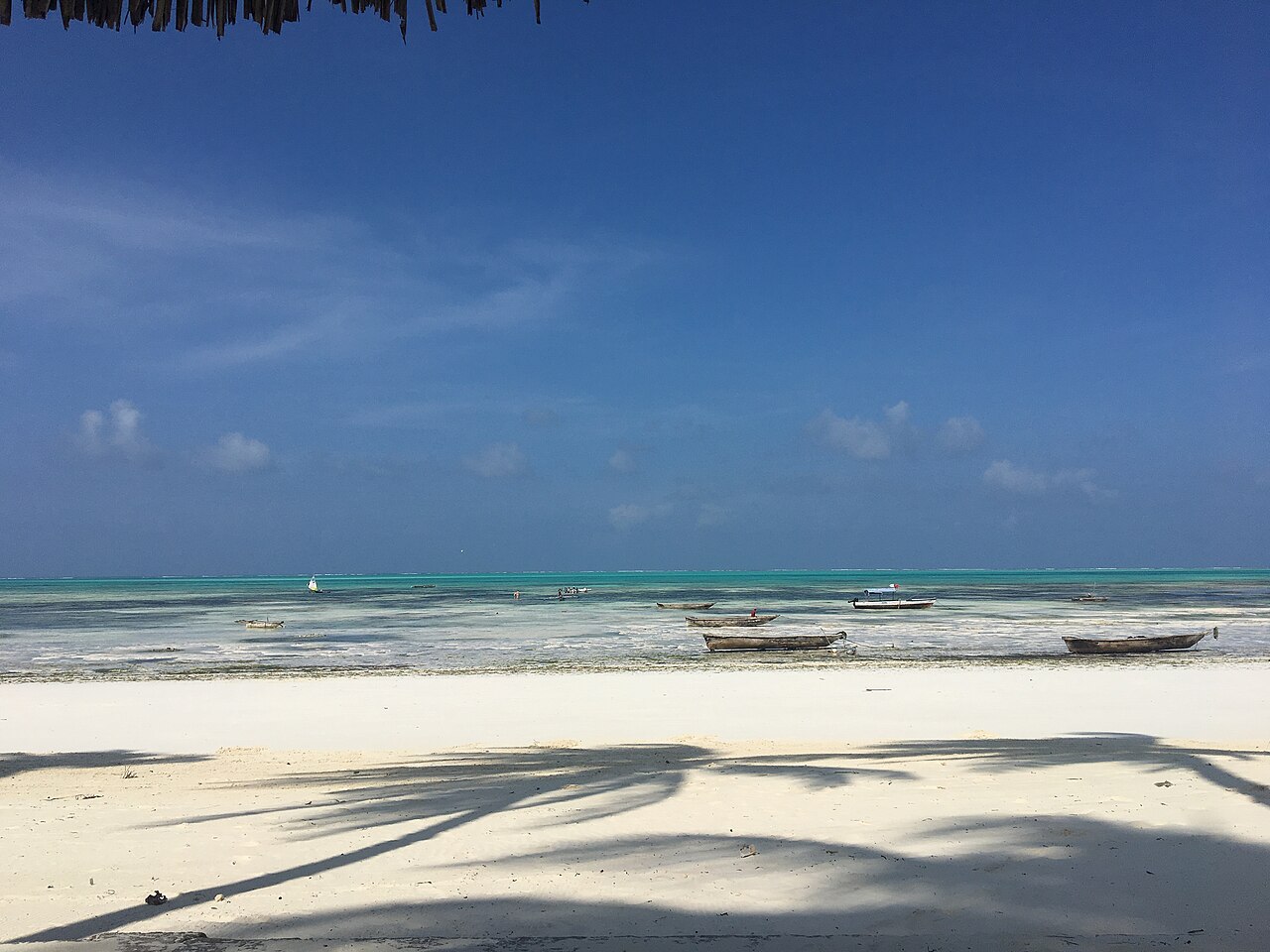 Jambiani Beach at low tide with boats offshore