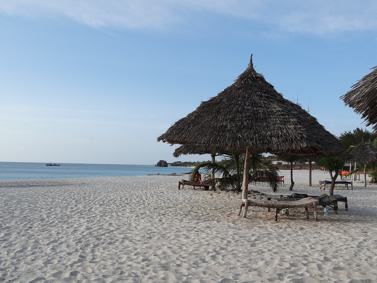 Wide sandy shore with shade shelters at Kendwa Beach, Zanzibar
