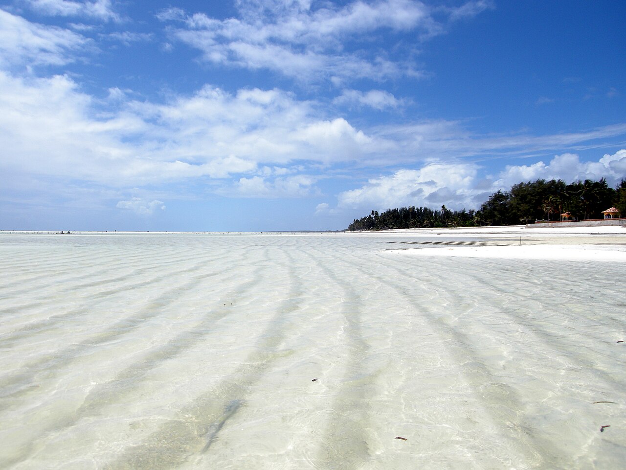 Shallow water and exposed sand at Paje Beach at low tide