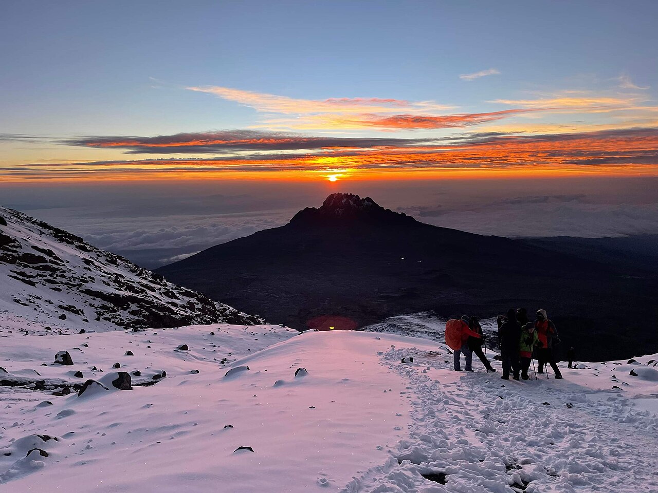 Snowy terrain and sunrise near the summit of Mount Kilimanjaro
